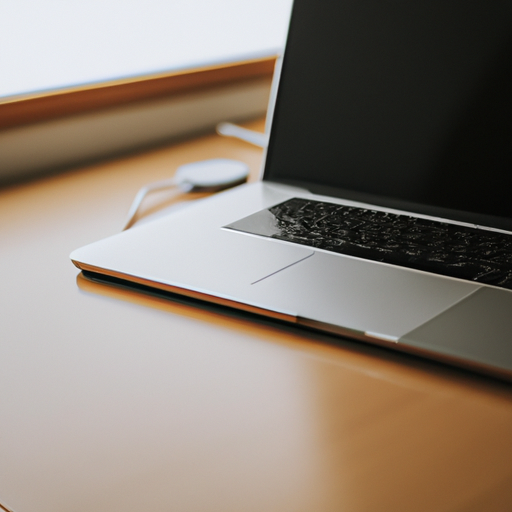 A well-used and slightly worn m1 macbook pro on a minimalist desk setup
