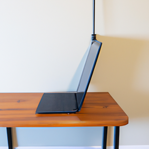 An action shot of the desk being raised or lowered with a laptop and a monitor on it